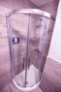 a shower with a glass door in a bathroom at Belmont Llandudno in Llandudno +37 photos