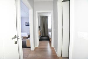 a corridor of a hotel room with a bedroom at Hotel Auto Grill Roberti in Tepelenë