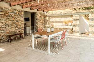 a dining room with a table and chairs at Skiathos Symbol Villas in Achladies