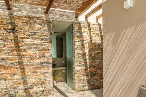 a stone wall in the hallway of a house at Skiathos Symbol Villas in Achladies