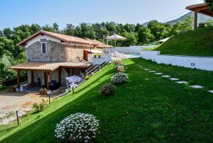 a large yard with a house and a building at Due Passi B&B in Marano Marchesato