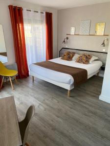 a bedroom with a large bed with red curtains at Amadour Hôtel in Rocamadour