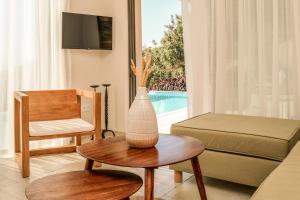a living room with a vase on a table at Skiathos Symbol Villas in Achladies