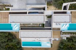 an overhead view of a building with blue roofs at Skiathos Symbol Villas in Achladies