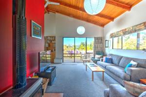 a living room with a couch and a tv at 34 Denby Place in Hanmer Springs