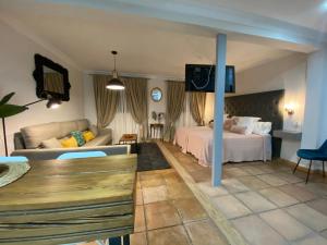 a hotel room with a bed and a couch at Hotel Convento La Gloria in Seville