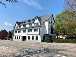 a large white building on the side of a street at Hotel Mardaga in As