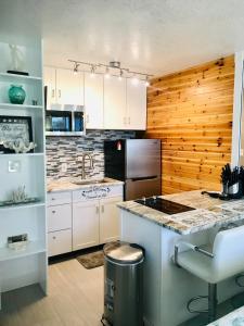 a kitchen with white cabinets and a counter top at Just Beachy -Ocean View at Symphony Beach Club in Ormond Beach