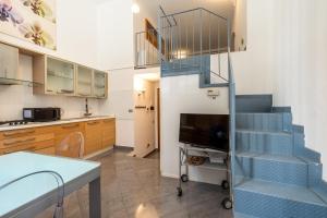 a kitchen with a blue staircase in a room at Esclusivo Loft In Porta Romana, a 250m dalla Bocconi in Milan