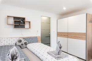 a bedroom with a bed and a closet at Maul - Lator vendégház in Villány