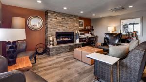 a living room with a couch and a fireplace at Best Western Hi-Desert Inn in Tonopah