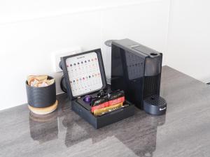 a desk with a computer and other items on it at The Esplanade Motel in Warners Bay