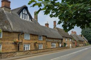 a row of thatched cottages in a village at Banbury Wroxton House Hotel in Banbury