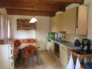 a kitchen with a table and a dining room at Ferienhaus Zopfhäusl in Böbrach