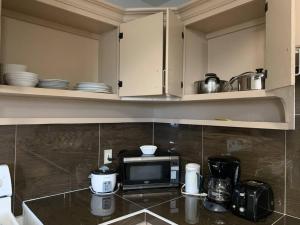 a kitchen with a counter top with a microwave at Private/Central 3 Bedroom Home in Hagatna