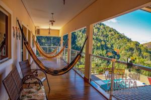 Zimmer mit einer Hängematte auf einem Balkon mit Aussicht in der Unterkunft Chácara Vovô Elson Fonseca - um refúgio nas Montanhas Capixabas in Marechal Floriano