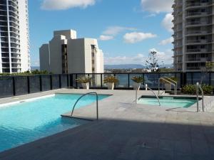 a swimming pool on the roof of a building at Circle on Cavill - HR Surfers Paradise in Gold Coast