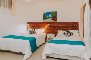 Postel nebo postele na pokoji v ubytování Galápagos Isabela Hotel Loja + 37 fotografií