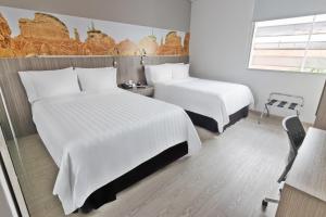 Ένα ή περισσότερα κρεβάτια σε δωμάτιο στο GHL Hotel Neiva