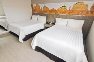 Ένα ή περισσότερα κρεβάτια σε δωμάτιο στο GHL Hotel Neiva