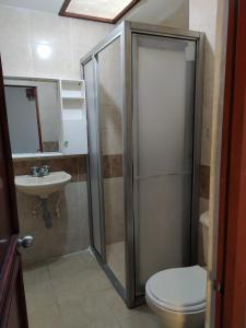 a bathroom with a shower and a toilet and a sink at Casa Turistica JM in Armenia +14 photos
