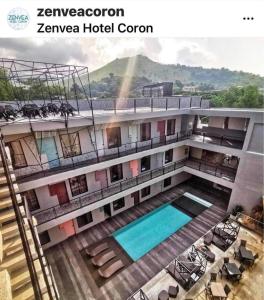 a view of a building with a swimming pool at Zenvea Hotel in Coron