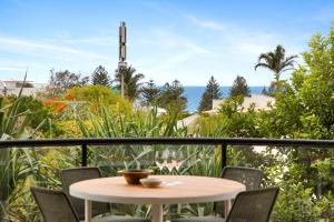 a table on a balcony with a view of the ocean at Da Vinci, Apartment 1, Sunshine Beach in Noosa Heads
