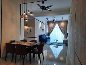 a dining room with a table and chairs and a ceiling fan at The Awantara Homestay - Seroja Hills in Sepang