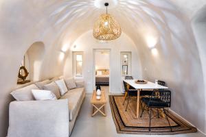 a living room with a couch and a table at Hill Suites in Fira