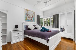 a bedroom with a bed with a stuffed animal on it at Golden Sands at Beachmere in Beachmere