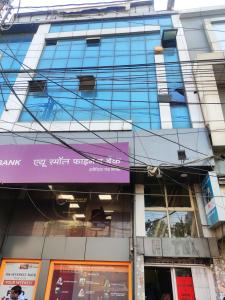 a tall building with a purple sign on it at Hotel Thakur Shri in Bhopal