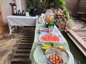 a table with fruits and vegetables on a table at Saythong boutique hotel in Chiang Khan