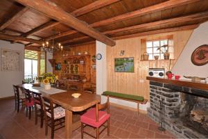 a kitchen and dining room with a table and a fireplace at Casa Busso in Esino Lario