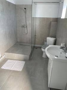 a bathroom with a shower and a toilet and a sink at CASA STORY in Ranca +16 photos