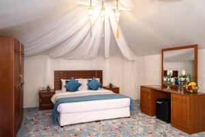 Voodi või voodid majutusasutuse Regency Sealine Camp toas