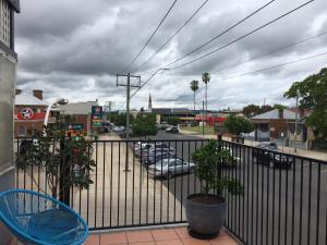 a balcony with a view of a parking lot with cars at Central Motel Mudgee in Mudgee