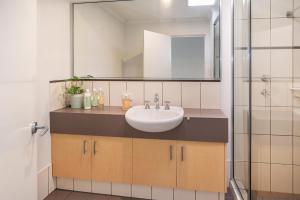 a bathroom with a sink and a mirror at Villa on Fearn in Margaret River Town