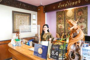 a woman standing behind a counter in a store at Ban Ao Thong in Trang