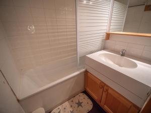 a bathroom with a sink and a shower and a tub at Appartement Valmorel, 1 pièce, 4 personnes - FR-1-356-254 in Valmorel