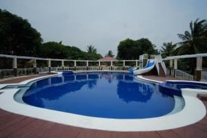 a large swimming pool with a slide and a playground at Winter's Farm Resort in Milagros