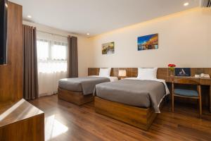 Postel nebo postele na pokoji v ubytování Avenis Hotel
