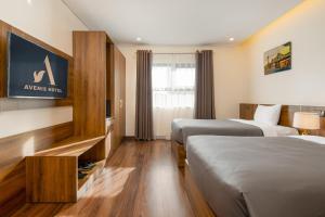 Postel nebo postele na pokoji v ubytování Avenis Hotel
