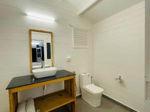 a bathroom with a sink and a toilet at Cocos Beach Resort in Palolem