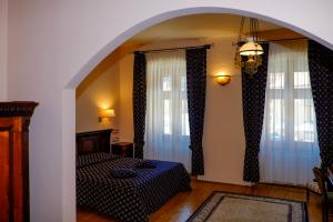 a room with a bed and a window at Casa Wagner in Braşov