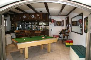 a room with a pool table and a bar at Ponciana Superior Guesthouse in Hartbeespoort