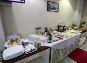 a table filled with food and plates of food at Christi's Hotel Borova in Korçë