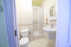 a bathroom with a toilet and a sink at "Willa Millennium" in Miedzygorze +28 photos