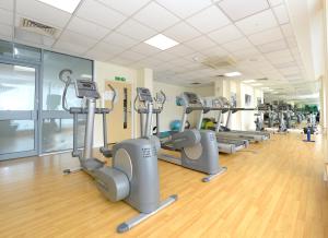a gym with a row of treadmills and machines at Woking Town Centre - Parking Included by Deilamy Homes in Woking