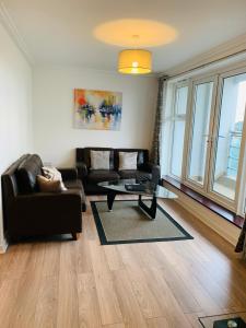 a living room with a couch and a coffee table at Woking Town Centre by Deilamy Homes in Woking
