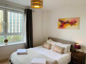 a bedroom with a bed and a window at Woking Town Centre by Deilamy Homes in Woking